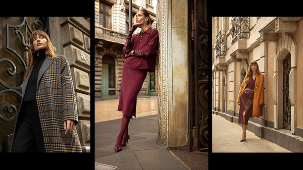 Banner der Joseph Ribkoff Kollektion Herbst Winter 2025 bei Laster Fashion Wien. Drei Modelle präsentieren elegante Outfits: links ein karierter Mantel in Braun und Grau über schwarzer Hose und Rollkragenpullover, in der Mitte ein weinrotes Ensemble mit Rock und Bluse, rechts ein senfgelber Mantel über einem bordeauxfarbenen Kleid. Die Aufnahmen sind vor architektonisch verzierten Stadthäusern inszeniert und strahlen urbane Eleganz und zeitlose Modernität aus.